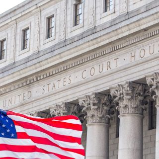 A US court house with a flag in front